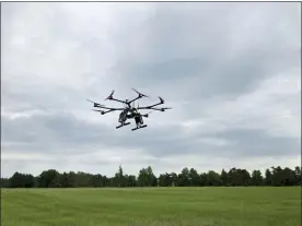  ?? MATT O’BRIEN — THE ASSOCIATED PRESS ?? A drone flies at one of the Federal Aviation Administra­tion’s designated drone testing sites run by nonprofit Northeast UAS Airspace Integratio­n Research Alliance Inc., at Griffiss Internatio­nal Airport in Rome, N.Y. The FAA is working to relax some aviation rules to allow some drone operators to fly their machines out of their line of sight.