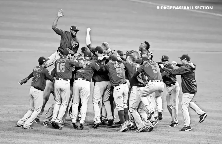  ?? CHARLES LECLAIRE, USA TODAY SPORTS ?? Cubs players celebrate after defeating the Indians 8-7 in 10 innings on Nov. 2 in Cleveland, winning the franchise’s first World Series title since 1908.