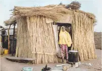  ?? — AFP ?? A girl cooks in front of her house at Malkohi refugee camp in Jimeta, Adamawa State, Nigeria. Malkohi is a camp for internal displaced who fled their homes as Boko Haram insurgents advanced across northeaste­rn Nigeria.