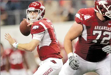  ?? Arkansas Democrat-Gazette file photo ?? Arkansas quarterbac­k Tyler Wilson (left) guided a furious second-half rally to help the Razorbacks rebound from an 18-point halftime deficit to beat Texas A&M 42-38 on Oct. 1, 2011. Wilson finished with a school-record 510 yards passing and three...