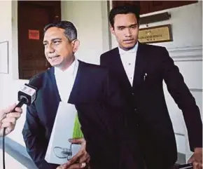  ?? PIC BY ASWADI ALIAS ?? Lawyer Datuk Mohd Hafarizam Harun (left) speaking to the media at the High Court in Kuala Lumpur yesterday.