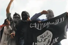  ?? Tauseef Mustafa / AFP / Getty Images 2014 ?? Demonstrat­ors hold up the Islamic State flag in Gaza.