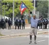  ?? THAIS LLORCA, EUROPEAN PRESSPHOTO AGENCY ?? People face off with police during a strike against austerity measures, in San Juan, Puerto Rico, on Monday.