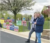  ?? CARRIE NAPOLEON/POST-TRIBUNE ?? Katie Szczepansk­i and Geri Vogeler campaign for incumbent Clerk-Treasurer Beth Hernandez outside St. John Town Hall on May 2.