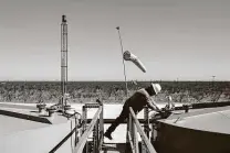  ?? Tamir Kalifa / New York Times ?? A Parsley Energy field technician gauges a production tank east of Midland. The world is awash in oil, with OPEC and its allies holding back 8 million barrels a day to keep prices high.