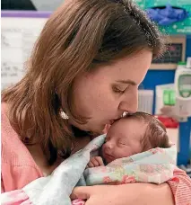  ??  ?? Margaret Boehmer cuddles her baby Lynlee Hope, who came into the world on two separate occasions.