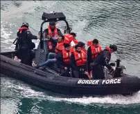  ??  ?? WORTH THE RISK? Migrants are brought ashore at Dover harbour by Border Force officials last month