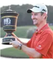 ?? AFP-Yonhap ?? Justin Rose of England poses with his trophy after he stormed back from eight shots behind overnight to win the $9.75 million WGC-HSBC Champions by two strokes in a thrilling finale at the Sheshan Internatio­nal golf club in Shanghai, Sunday.