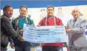  ?? HT PHOTO ?? Prem Dorjee Khrimey receiving his cheque from CM Pema Khandu and Union minister Kiren Rijiju on Thursday.