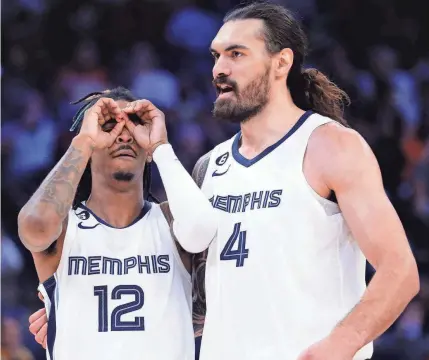  ?? PETRE THOMAS/USA TODAY SPORTS ?? Grizzlies guard Ja Morant (12) reacts next to center Steven Adams after an assist against the Pelicans at Fedexforum.