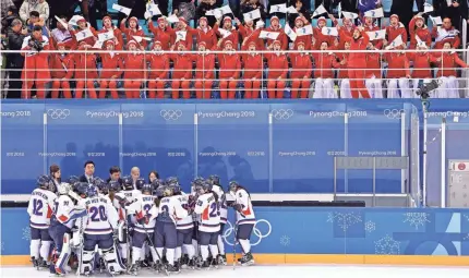  ??  ?? As North and South Korea joined forces for the Korean women’s ice hockey team that faced off Saturday against Switzerlan­d, the North’s cheer squad captivated the crowd. PHOTOS BY ANDREW NELLES/USA TODAY SPORTS