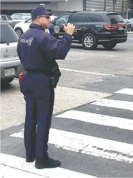  ?? THE ASSOCIATED PRESSS ?? Officer Ulises Villanueva directs traffic Thursday at an intersecti­on in San Juan, Puerto Rico. Traffic lights are out across most of the island amid power outages caused by Hurrricane Maria.