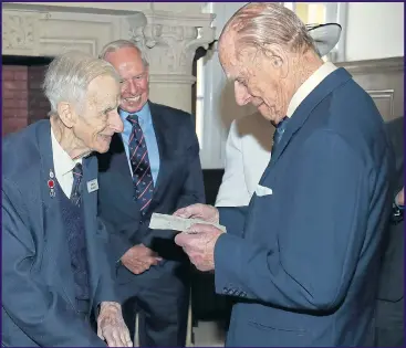  ??  ?? Commander Keith Evans yesterday, showing Philip the letter the Prince had sent to him in 1947