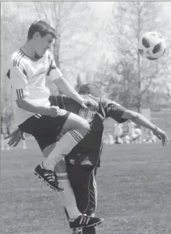  ?? Herald photo by Dale Woodard ?? Marcus Menzies of the LFC men’s team gets his head on the ball against Edmonton Green & Gold’s Cam Barrett during Alberta Major Soccer League play Sunday afternoon at the Servus Sports Centre.