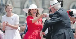 ?? JUSTIN TANG/THE CANADIAN PRESS ?? Sophie Grégoire Trudeau, centre, dances with Gov. Gen. David Johnston as Heritage Minister Mélanie Joly looks on, at Canada Day celebratio­ns on Parliament Hill.