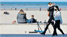  ??  ?? People wear face masks near the beach in Dunkirk as the city bids to bring down Covid cases