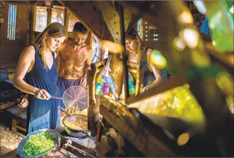  ?? Photograph­s by Marcus Yam Los Angeles Times ?? DAM OPPONENT Imad Beainy and Nadia Safa prepare a meal at home. Fellow activists have seen Beainy as an almost talismanic figure.