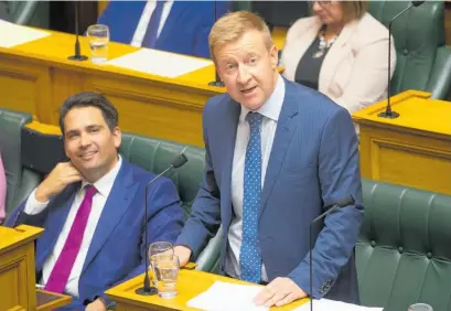  ?? Picture / Mark Mitchell ?? Jonathan Coleman gives his valedictor­y speech to Parliament while Simon Bridges watches on.