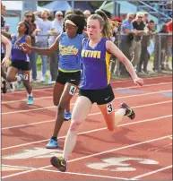  ?? Christian Abraham / Hearst Connecticu­t Media ?? Newtown’s Carly Swierbut wins the 100 meters at the SWC championsh­ips Wednesday.