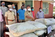  ??  ?? Tamil Nadu police officers inspecting the bags of turmeric seized from smugglers