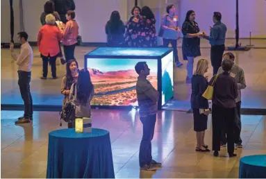  ?? TOM TINGLE/THE REPUBLIC ?? People peruse the Water Public Art Challenge displays Wednesday at the Phoenix Art Museum.