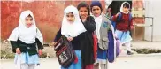  ??  ?? Afghan refugee schoolgirl­s leave their school in the Kabobayan refugee camp, Peshawar.
