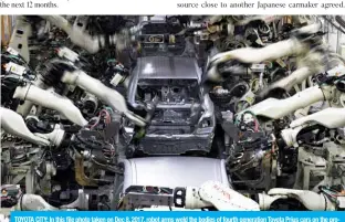  ?? — AFP ?? TOYOTA CITY: In this file photo taken on Dec 8, 2017, robot arms weld the bodies of fourth generation Toyota Prius cars on the production line at the company’s Tsutsumi assembly plant in Aichi prefecture.