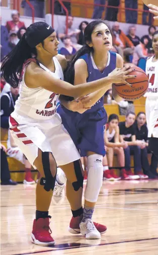  ?? CLYDE MUELLER/THE NEW MEXICAN ?? St. Michael’s Monse Camarena-Leija, right, is fouled by Las Vegas Robertson’s Maria Barela on Friday in a Class 4A State Tournament game in Las Vegas, N.M. The No. 3 seed Lady Cardinals won 51-36 over the No. 14 Lady Horsemen. With the win, Robertson...