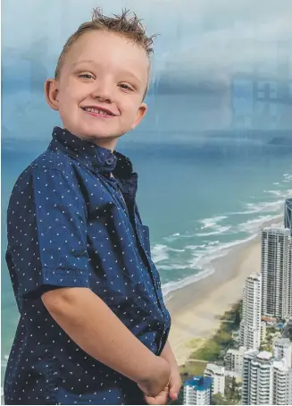 ?? Picture: Jerad Williams ?? Gold Coast boy William O'Rourke, 6, who has a rare form of tumour, at the Skypoint Observatio­n Deck at Q1 in Surfers Paradise, which will be lit up blue in May as part of World Neurofibro­matosis Awareness month.