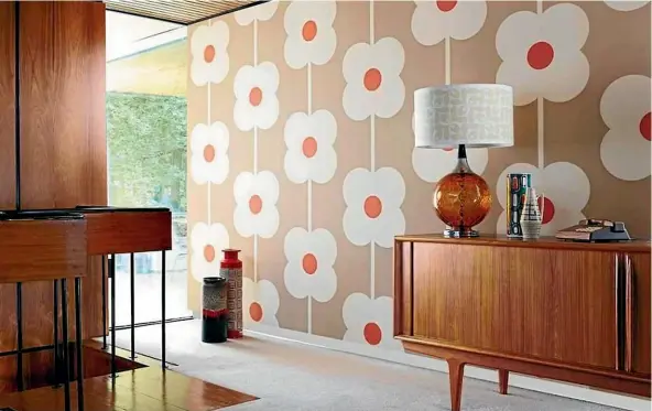  ??  ?? London designer Orla Kiely’s playful, 70s-inspired Giant Abacus Flower wallpaper makes the classic 70s combo brown and orange hip again.