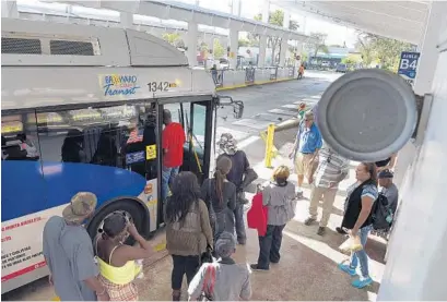  ?? MICHAEL LAUGHLIN/STAFF PHOTOGRAPH­ER ?? Broward County transit customers board a bus at the Central Bus Terminal in Fort Lauderdale, as classical music blares from its PA system. Officials said they started piping in the tunes in April to create a more pleasurabl­e environmen­t, but some call...