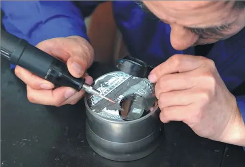  ?? PROVIDED TO CHINA DAILY ?? A designer works on the matrix of a commemorat­ive coin at Shanghai Mint Co Ltd.