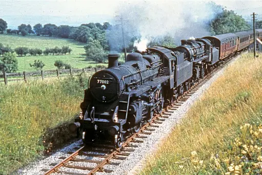  ?? COLOUR RAIL ?? ABOVE On August 12 1961, another double‑headed westbound Blackpool express heads through Smardale with Standard 3 No. 77002 at the head.