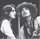  ?? NETFLIX ?? Folk icons Joan Baez and Bob Dylan perform together during the Rolling Thunder Revue.