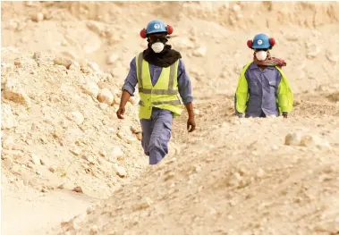  ??  ?? In this file photo taken during a government­organized media tour, workers walk back to Al-Wakrah Stadium worksite being built for the 2022 World Cup in Doha. (AP)