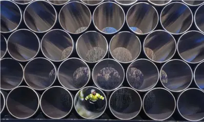  ?? Photograph: Jens Buettner/AP ?? Pipes stored for the Nord Stream 2 gas pipeline.