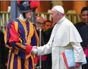  ?? ALESSANDRO DI MEO/ANSA VIA AP ?? Pope Francis shakes hands with a Swiss Guard as he leaves after opening of the 15th Ordinary General Assembly of the Synod of Bishops, at the Vatican, Wednesday.