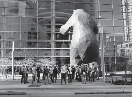  ??  ?? United States Army Corps of Engineers and other meet outside the Colorado Convention Center before heading inside the center for a walkthroug­h Monday in Denver.