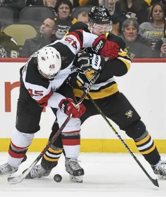  ?? Peter Diana/Post-Gazette ?? The Penguins’ Tanner Pearson battles Devils defenseman Sami Vatanen for a loose puck in a 6-3 loss Jan. 28 at PPG Paints Arena.