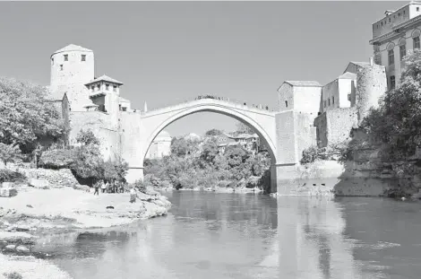  ?? RICK STEVES ?? The Bosnian city of Mostar and its famous bridge, which was rebuilt after being destroyed in the Yugoslav Wars of the 1990s.