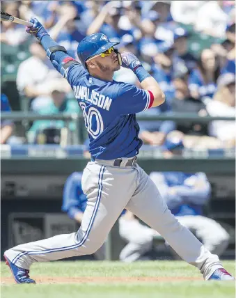  ?? STEPHEN BRASHEAR/GETTY IMAGES ?? Josh Donaldson of the Toronto Blue Jays hits a two-run home run during the first inning at Safeco Field on Sunday in Seattle, Wash. Toronto won the game 4-0.