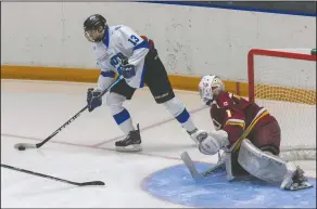  ?? NEWS PHOTO RYAN MCCRACKEN ?? South Alberta Hockey Academy U18 male prep forward Roman Cherniak steps out from behind the net with the puck while Edge School U17 goaltender Cam Hrdlicka defends during a Canadian Sport School Hockey League game on Friday, Oct. 16 at the Canalta Centre.