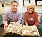  ?? ALEXA WELCH EDLUND/RICHMOND TIMES-DISPATCH ?? Beth Oxenham and Andy Castellano hold her mother, Anna Brauer Oxenham’s, photo album from the 1940’s. Castellano, originally from Virginia Beach, found it at a flea market in Lynchburg, tracked down Anna’s family in Richmond and returned it to Beth, who is Anna’s eldest daughter.