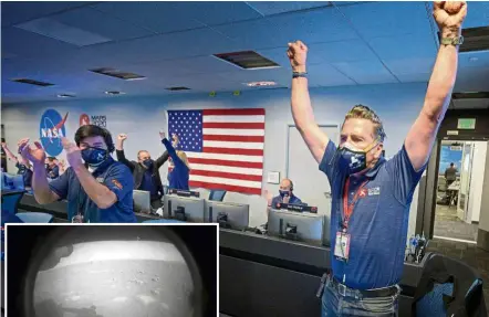  ?? — AFP ?? Key to success: The ‘Perseveran­ce’ rover team reacting in mission control after confirmati­on the spacecraft successful­ly touched down and soon after sent an image (inset) of the Red Planet back to Earth.