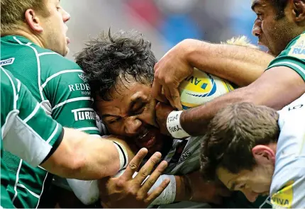  ?? REX ?? All action: Saracens’ returning Billy Vunipola is mobbed by the London Irish defence