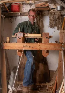  ??  ?? Mike hand-built his pole lathe, also known as a spring pole lathe, which uses the elasticity within a long pole as a return spring for a treadle. Pressing the treadle pulls on a cord that is usually wrapped around the piece of wood or billet that is being turned