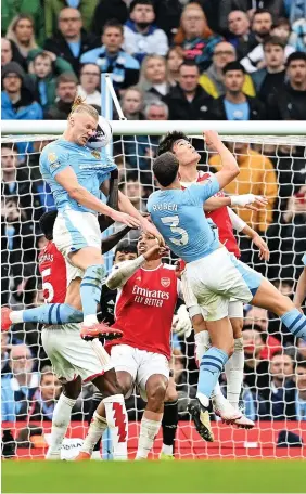  ?? Pictures: Peter Byrne/PA & Michael Regan/Getty Images ?? > Liverpool celebrate after Mohamed Salah put them 2-1 up against Brighton at Anfield, above left, while the clash between Manchester City and Arsenal was a poor goalless draw, above right