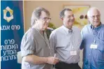  ?? (EMET Prize) ?? AMN FOUNDATION general manager Arie Dubson (center) poses with two of this year’s EMET Prize winners Oded Kotler (left) and Zelig Eshhar, at a luncheon celebratin­g the winners in July.