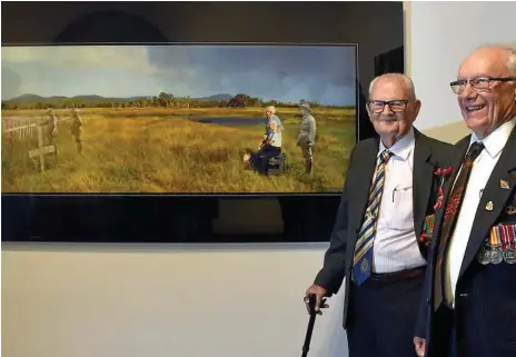  ?? Photo: Bev Lacey ?? SPECIAL MEMORIES: Ian Lade (left) and George Gnezdillff were overwhelme­d to see the photo-montage they are featured in at the Toowoomba Regional Art Gallery.