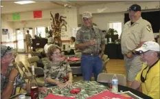  ?? WILLIAM ROLLER PHOTO ?? Andrew Hughan (second from right), California Department of Fish and Wildlife informatio­n officer and Ed McGrew, Sunbeam Lake RV Resort manager greet guests at the fourth Dove Hunt Dinner, Thursday.